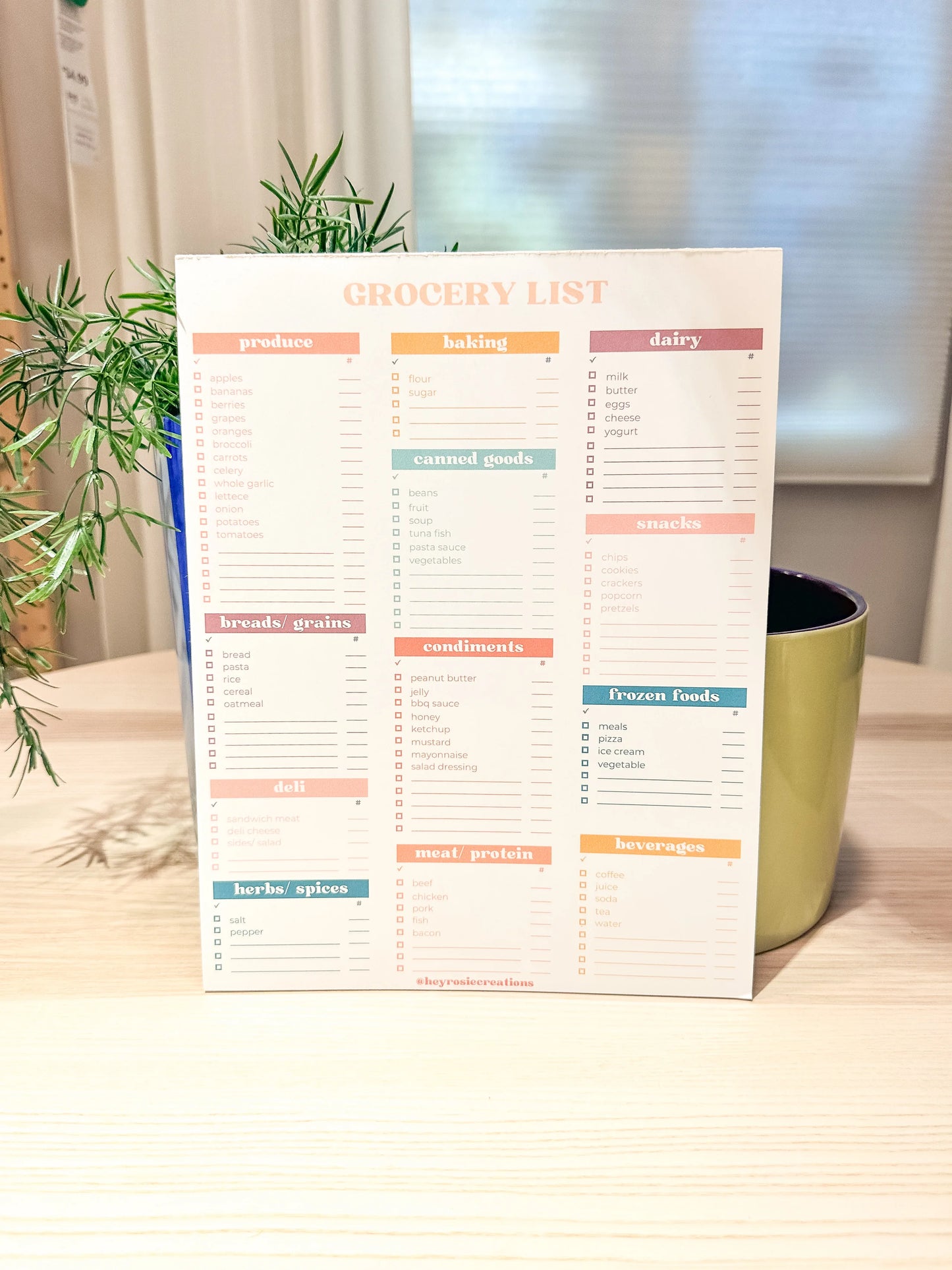 Weekly meal planner with sections for days of the week and space for meal ideas and grocery lists. Designed by Hey Rosie Creations